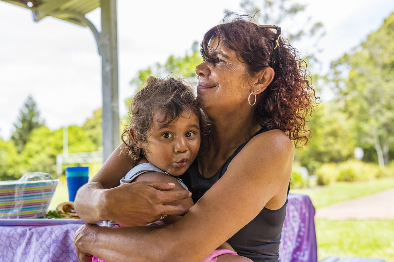 Aboriginal grandma hugging grandchild WEB RGB