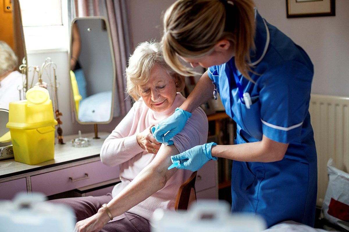 Older woman getting immunised WEB
